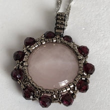 Load image into Gallery viewer, Rose quartz cabochon pendant framed by metallic steel-tone micro-beading with facetted garnet on a steel twisted French chain