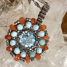 Load image into Gallery viewer, Beaded charm pendant with blue topaz center piece and mandala of larimar and carnelian with metallic steel micro-beading.