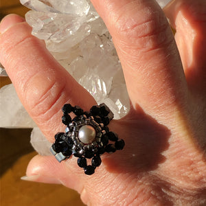 Beaded ring in the shape of a star with freshwater pearl centerpiece and mat metallic beaded band. Stunning!
