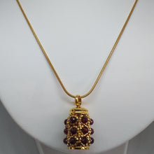 Load image into Gallery viewer, Facetted garnet and fine metallic gold glass bead encrusted tiny urn pendant. Lock of hair keepsake. Cremation jewellery.