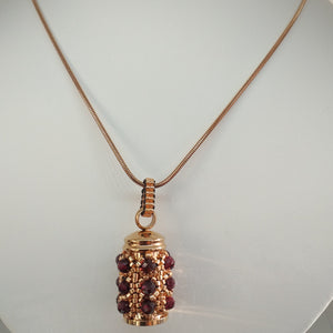 Facetted garnet and fine metallic glass bead encrusted tiny urn pendant. Rose-gold. Lock of hair keepsake. Cremation jewellery.