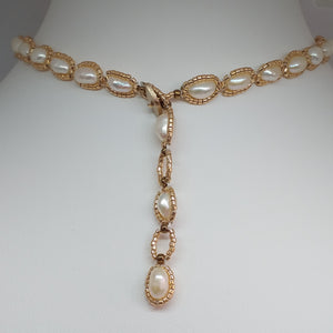 Showing adjustable back of bridal baroque pearl choker necklace with tasseled pendant and side drops