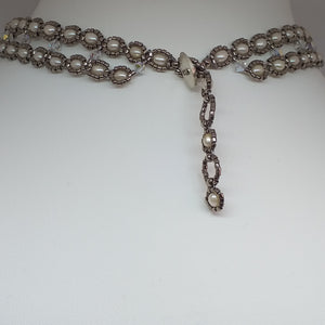 V shaped fine beaded pearl necklace with metallic micro-beads and Swarovski crystal. Adjustable toggle closure at the back.