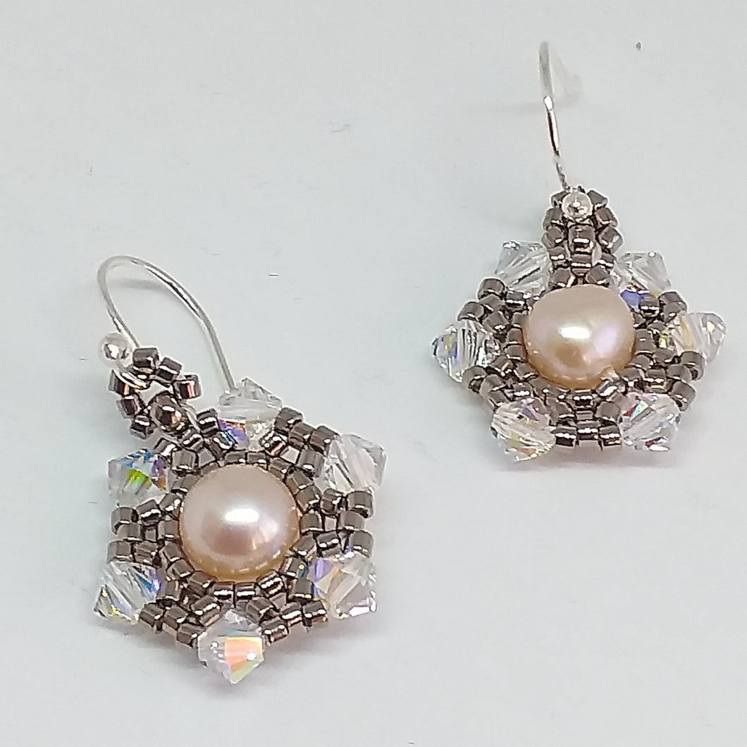 Fine beaded snowflake earrings with freshwater pearl centerpiece circled by a mandala of metallic micro-beading and Swarovski crystal