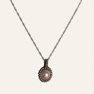 Pearl pendant necklace. Beaded jewellery. Large round freshwater pearl surrounded by metallic silver-tone glass beads.