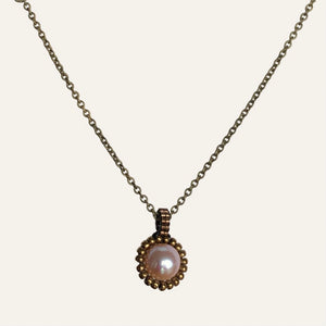 Pearl pendant necklace. Beaded jewellery. Large round freshwater pearl surrounded by metallic bronze-tone glass beads.