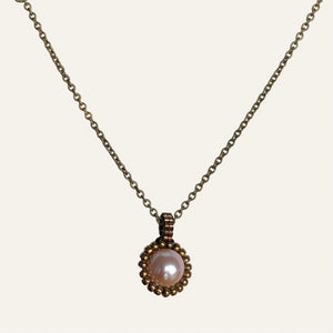Pearl pendant necklace. Beaded jewellery. Large round freshwater pearl surrounded by metallic bronze-tone glass beads.