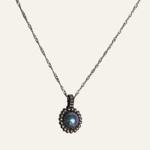 Pearl pendant necklace. Beaded jewellery. Large round blue freshwater pearl surrounded by metallic silver-tone glass beads.