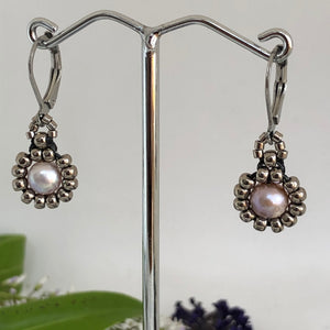 Beaded pearl earrings with silver-tone glass beads circling a freshwater pearl on lever-back steel wires