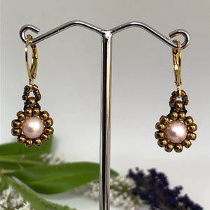 Beaded pearl earrings with bronze-tone glass beads circling a freshwater pearl on lever-back steel wires