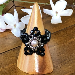 Beaded ring in the shape of a star with freshwater pearl centerpiece and mat metallic beaded band. Stunning!