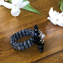 Load image into Gallery viewer, Beaded ring in the shape of a star with freshwater pearl centerpiece and mat metallic beaded band. Stunning!