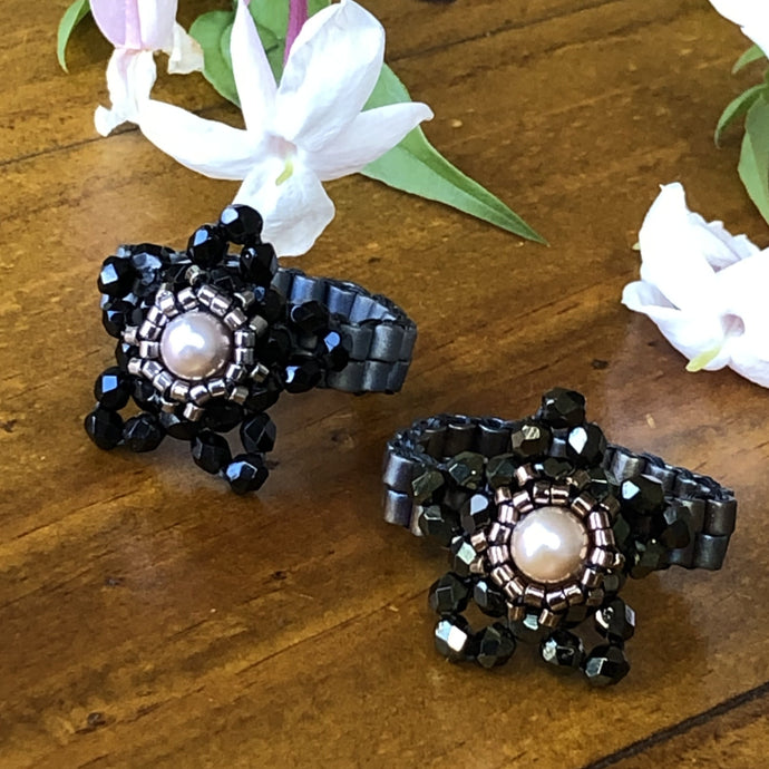Beaded ring in the shape of a star with freshwater pearl centerpiece and mat metallic beaded band. Stunning!