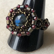 Load image into Gallery viewer, Fine beaded ring with facetted labradorite centerpiece and garnet mandala surround with garnet beaded band. Dark metallic bronze micro-beading 