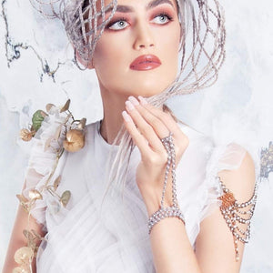 Bridal model wears beaded pearl slave-bracelet, glove in silver tones and natural freshwater pearl