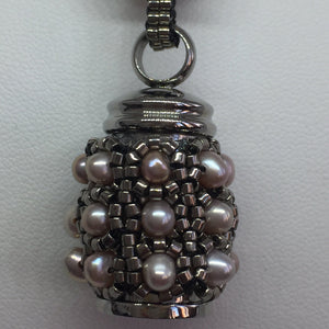 Cremation jewellery. Pearl encrusted fine beaded urn pendant on pearl and metallic beaded chain