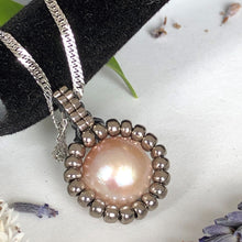 Load image into Gallery viewer, Pearl pendant necklace. Beaded jewellery. Large round freshwater pearl surrounded by metallic silver-tone glass beads.