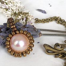 Load image into Gallery viewer, Pearl pendant necklace. Beaded jewellery. Large round freshwater pearl surrounded by metallic bronze-tone glass beads.