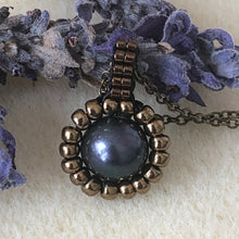 Load image into Gallery viewer, Pearl pendant necklace. Beaded jewellery. Large round freshwater black pearl surrounded by metallic bronze-tone glass beads.