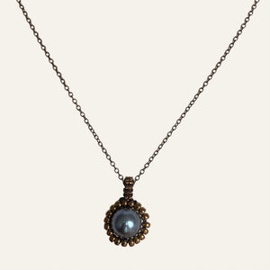 Pearl pendant necklace. Beaded jewellery. Large round blue freshwater pearl surrounded by metallic bronze-tone glass beads.