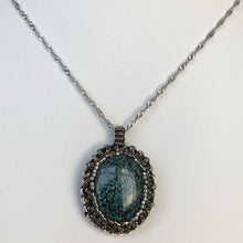 Load image into Gallery viewer, Tibetan Turquoise cabochon pendant framed by a cameo of glass micro-beading in metallic silver tone on a diamond cut steel twisted French chain