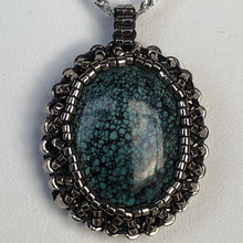Load image into Gallery viewer, Tibetan Turquoise cabochon pendant framed by a cameo of glass micro-beading in metallic silver tone
